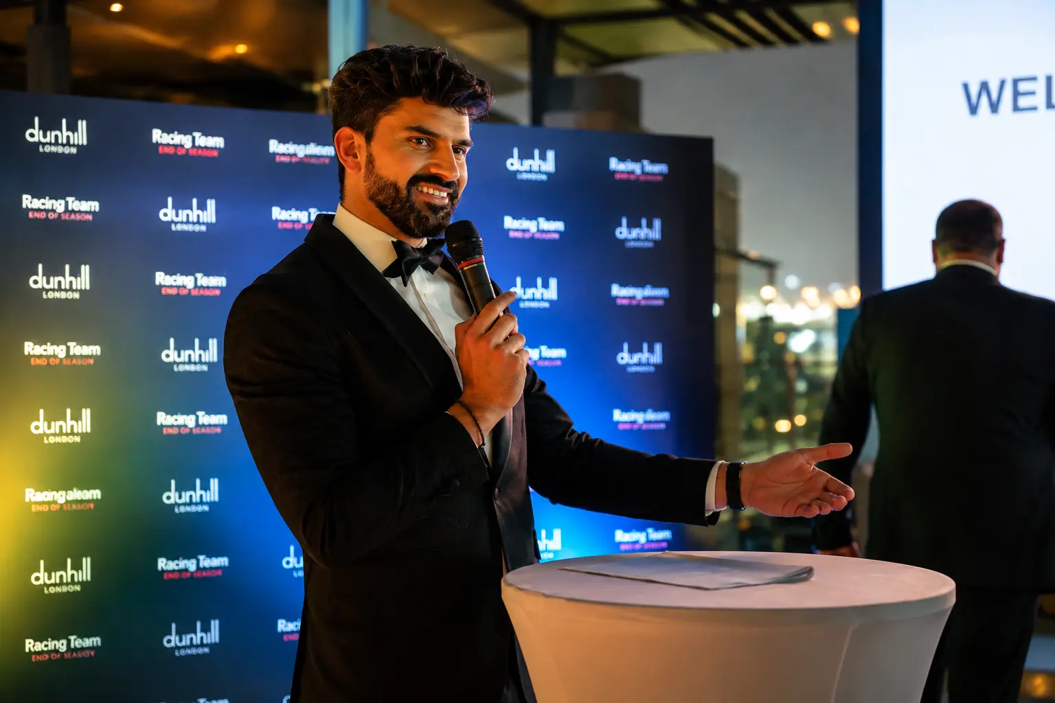 Corporate comedian and event host speaking on stage at a Dubai business event, engaging attendees with clean comedy and professional entertainment.