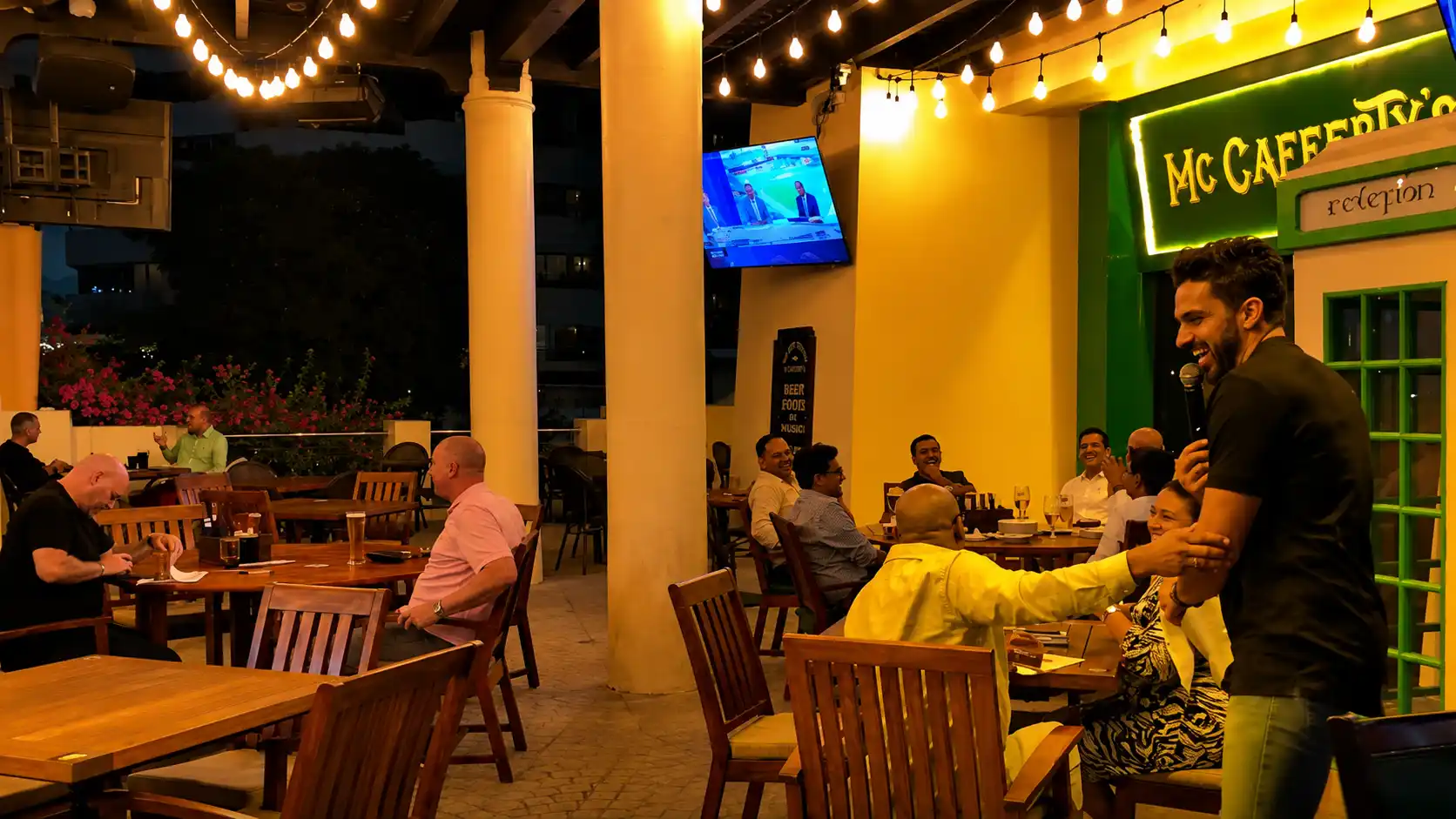 Professional quiz master entertaining guests at a Dubai venue, engaging the audience with interactive trivia during a lively corporate quiz night under warm ambient lighting.